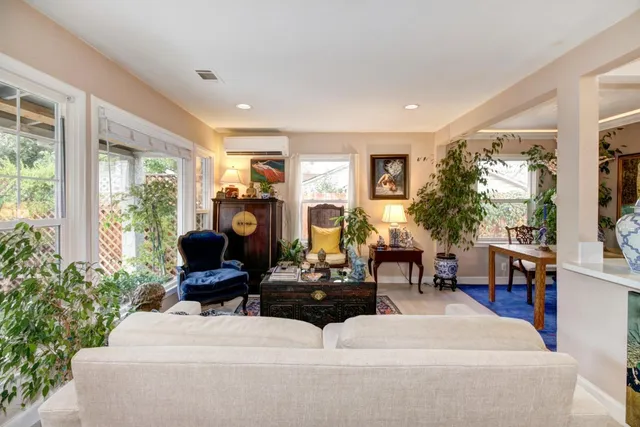 a living room with furniture a window and a flat screen tv