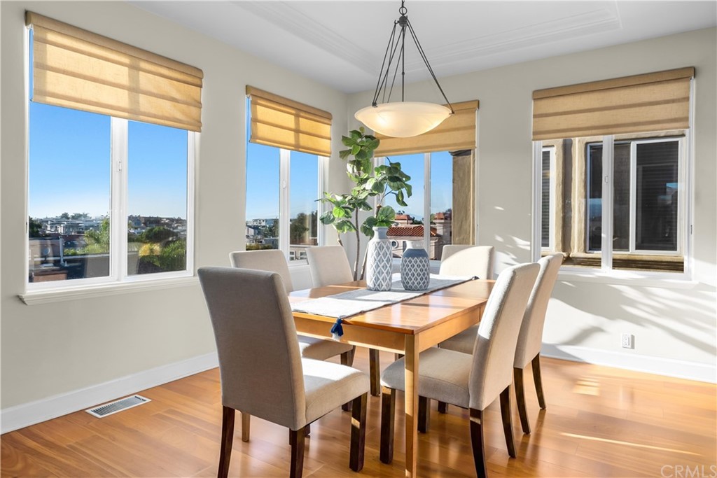 644 10th Street Hermosa Beach, CA 90254 - Photo 16 of 60 a living room with furniture a fireplace and kitchen view