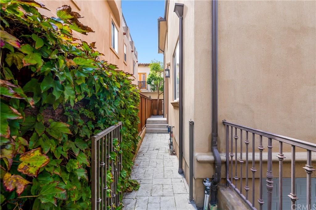 644 10th Street Hermosa Beach, CA 90254 - Photo 55 of 60 a view of a pathway of a house with plants and wooden fence