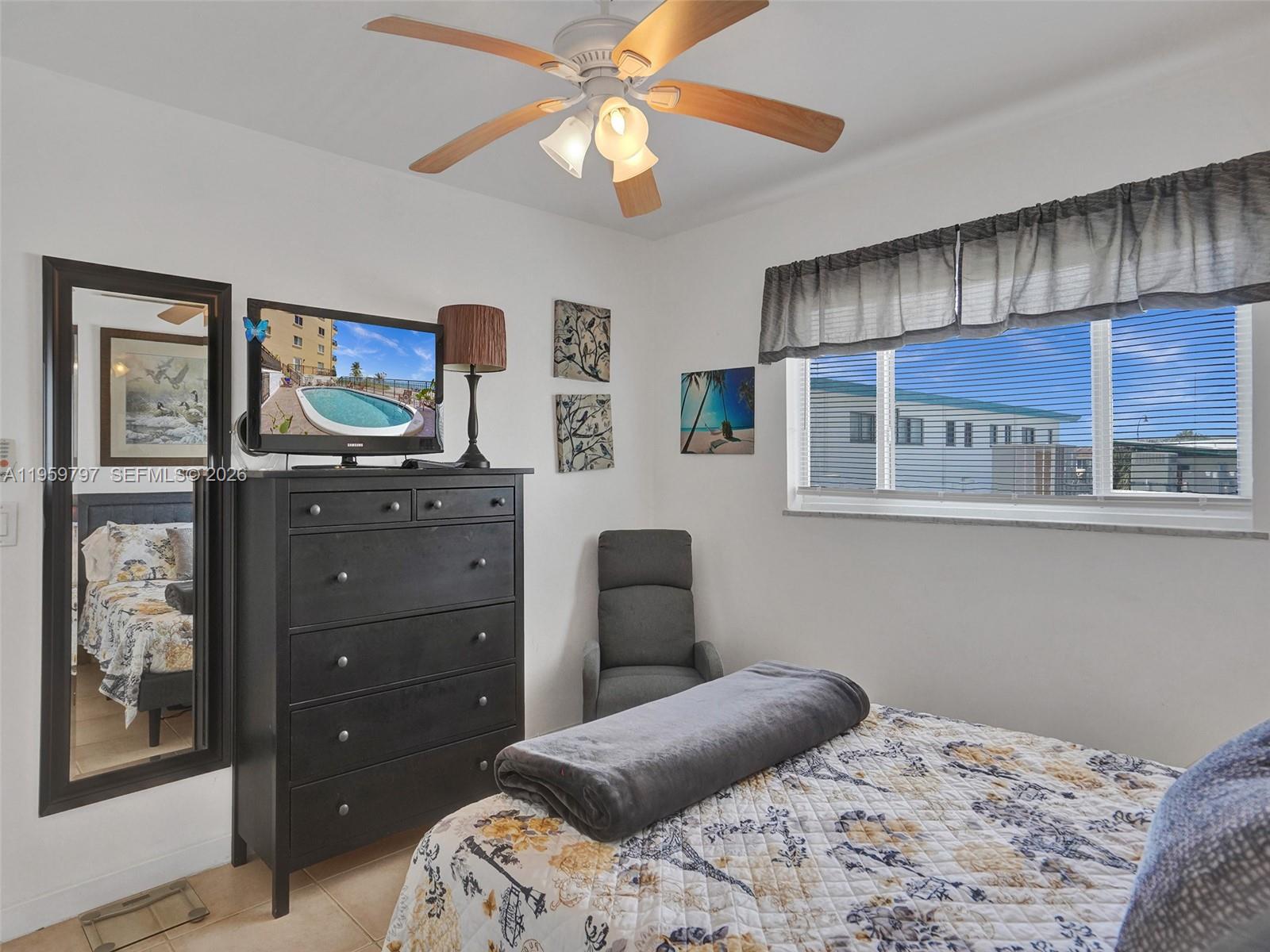 1815 North Surf Road, Unit 202 Hollywood, FL 33019 - Photo 11 of 32 a bedroom with a bed and a dresser