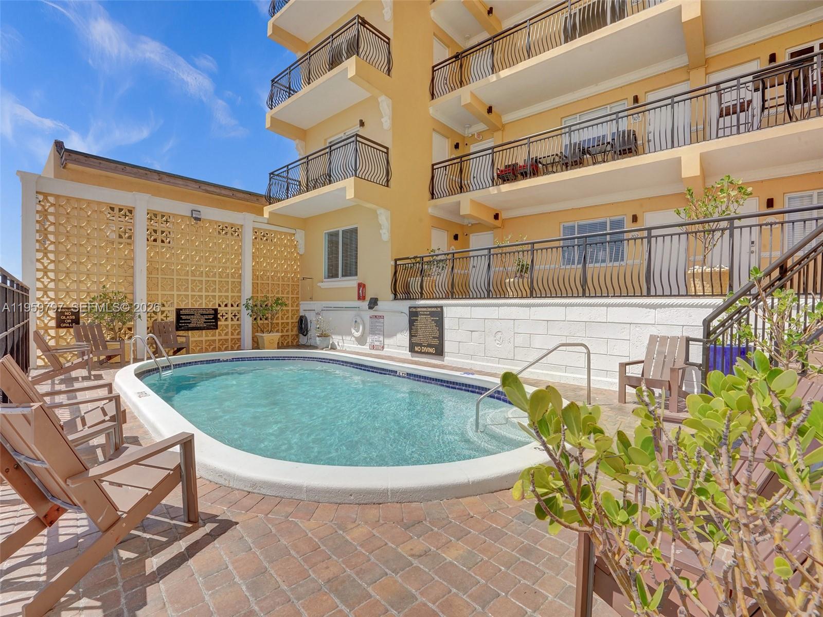 1815 North Surf Road, Unit 202 Hollywood, FL 33019 - Photo 27 of 32 a view of swimming pool with outdoor seating
