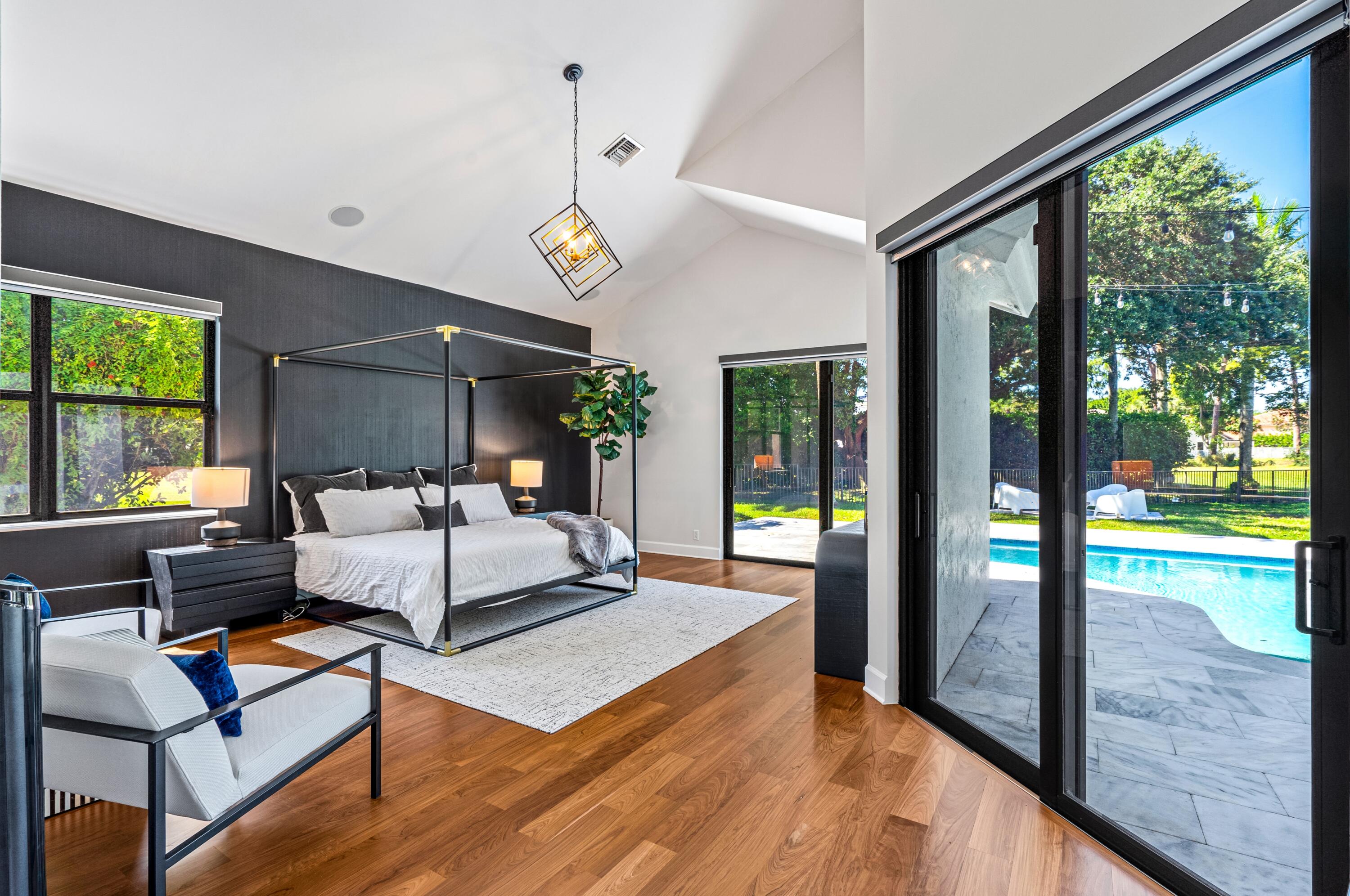 3098 Northwest 60th Street Boca Raton, FL 33496 - Photo 12 of 30 a living room with couch floor to ceiling windows and a dining table