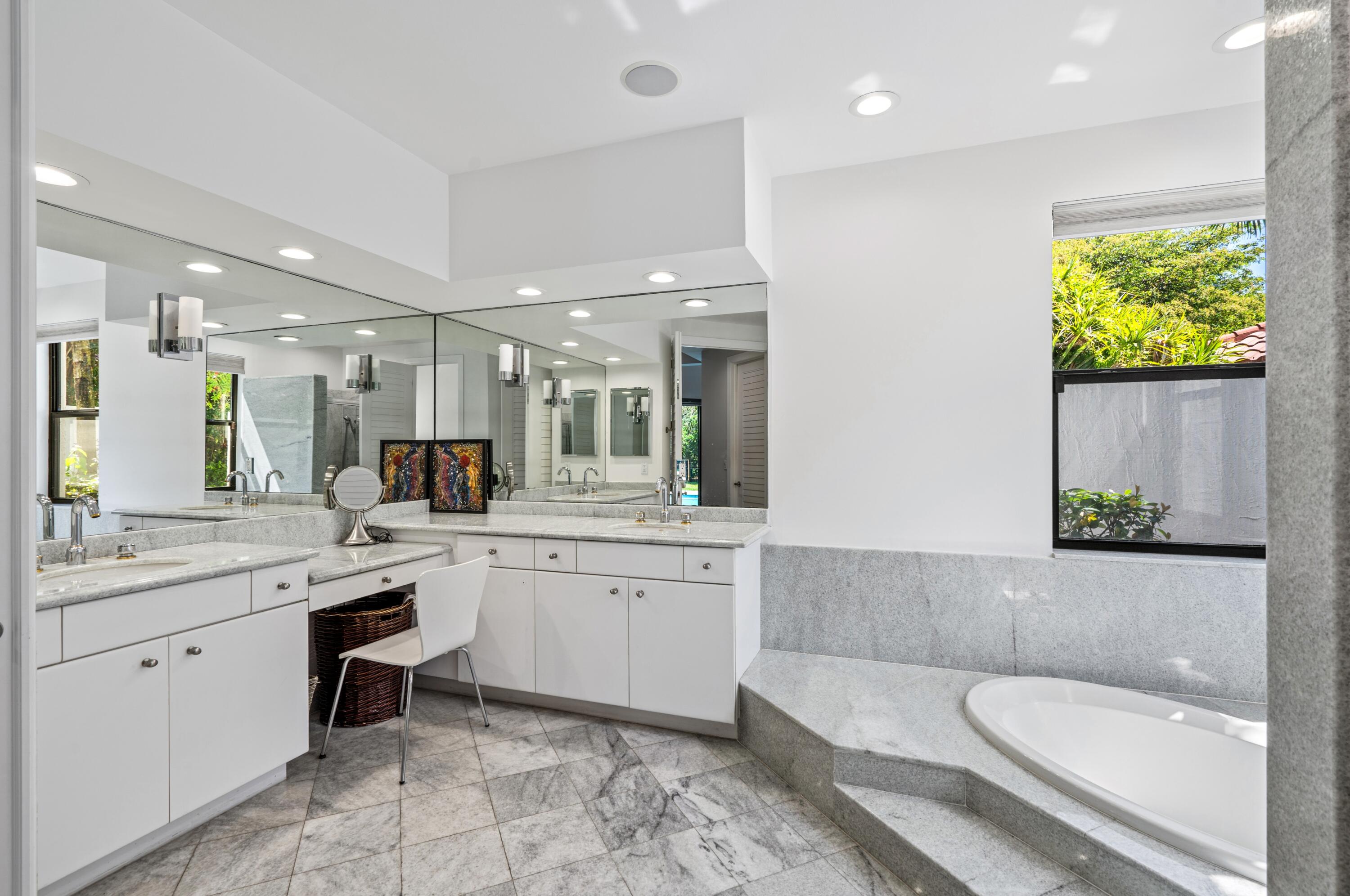 3098 Northwest 60th Street Boca Raton, FL 33496 - Photo 15 of 30 a bathroom with a granite countertop sink mirror and bathtub