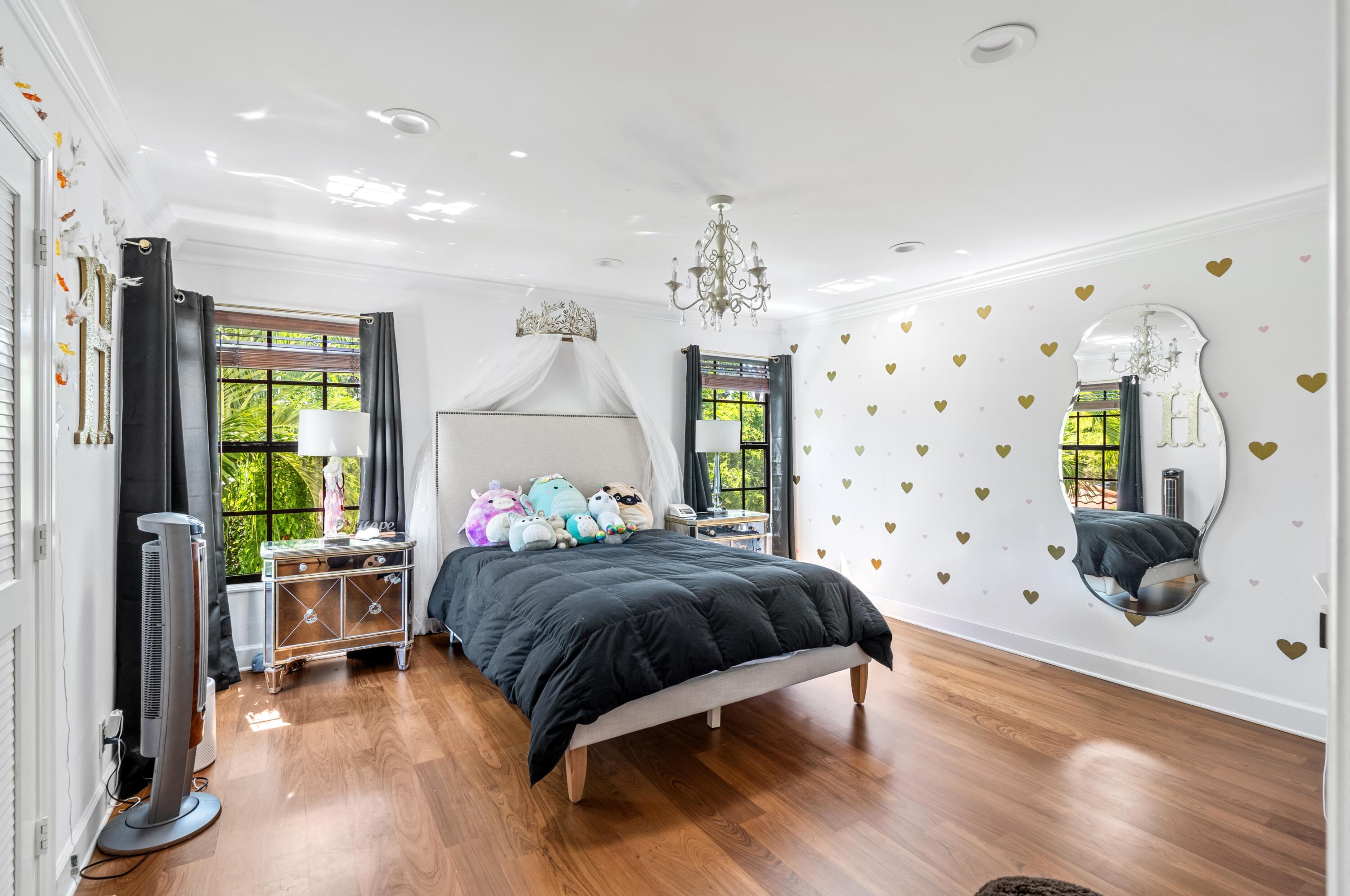 3098 Northwest 60th Street Boca Raton, FL 33496 - Photo 23 of 30 a bedroom with a bed and a flat tv screen on dresser