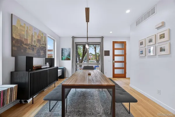 a large kitchen with stainless steel appliances kitchen island hardwood floor and a sink