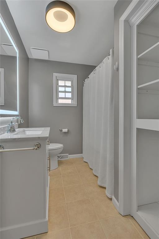 1044 Charles Street Monaca, PA 15061 - Photo 18 of 31 a bathroom with a toilet a sink and a mirror