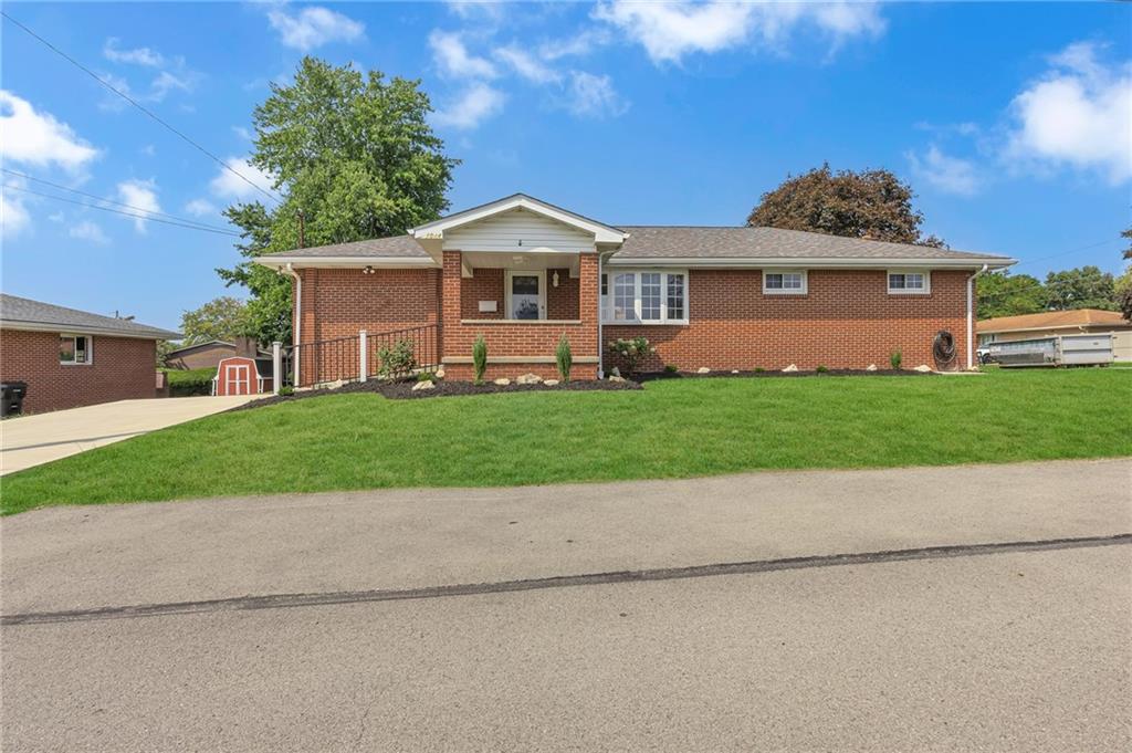 1044 Charles Street Monaca, PA 15061 - Photo 2 of 31 a front view of a house with a garden and yard