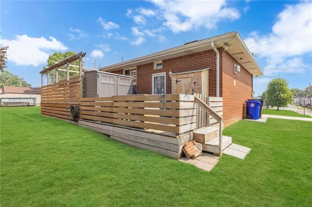a view of a backyard with a garden and deck