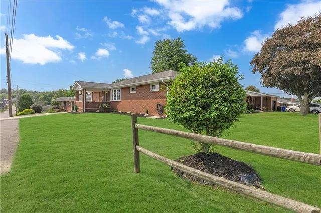 a view of an house with backyard space and garden