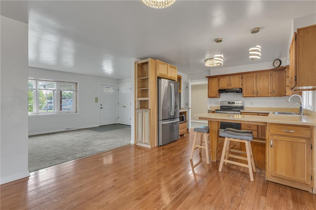 1044 Charles Street Monaca, PA 15061 - Photo 5 of 31 a kitchen with stainless steel appliances a stove a refrigerator and a oven