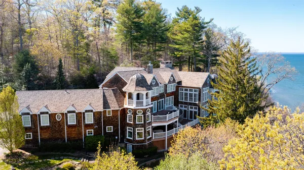 a view of a big house with wooden fence