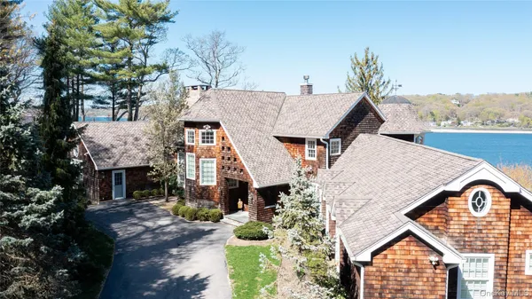 a aerial view of a house with a yard and potted plants