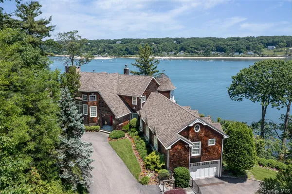 an aerial view of a house with a lake view
