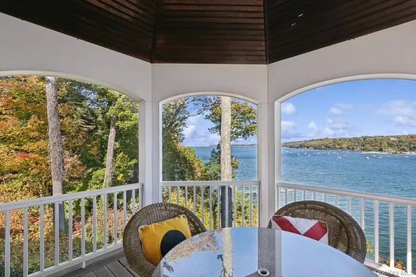 a balcony view with a large window and furniture