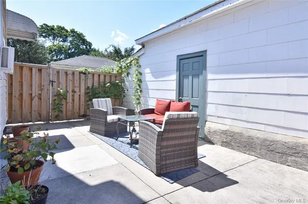 a wooden bench sitting in front of a house