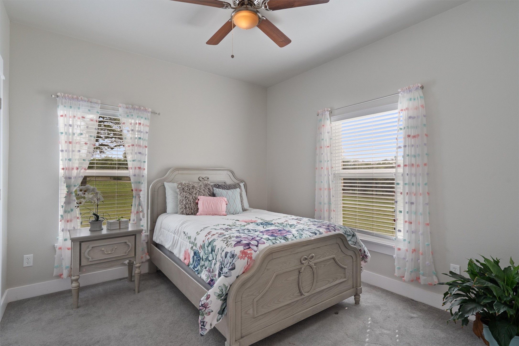 13105 Rooster Springs Road Austin, TX 78737 - Photo 17 of 38 This room features light gray walls, two windows with horizontal blinds, and a ceiling fan