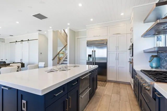 a kitchen with stainless steel appliances granite countertop a stove and a refrigerator