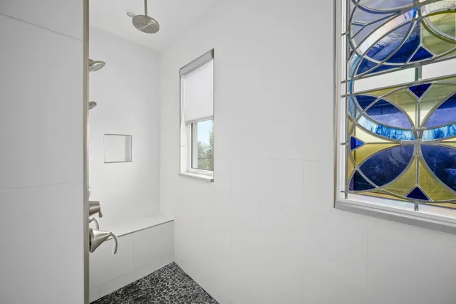 a view of a room that has a painting on the wall