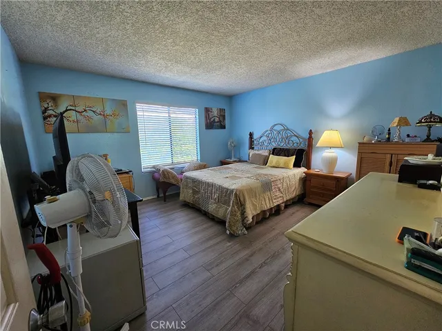 a bedroom with two beds and a desk