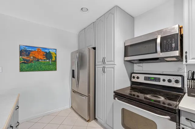 a kitchen with granite countertop a stove and a refrigerator