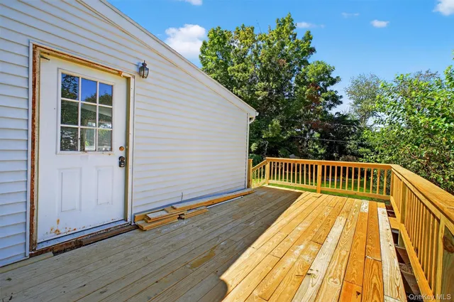 a view of balcony with wooden floor and fence