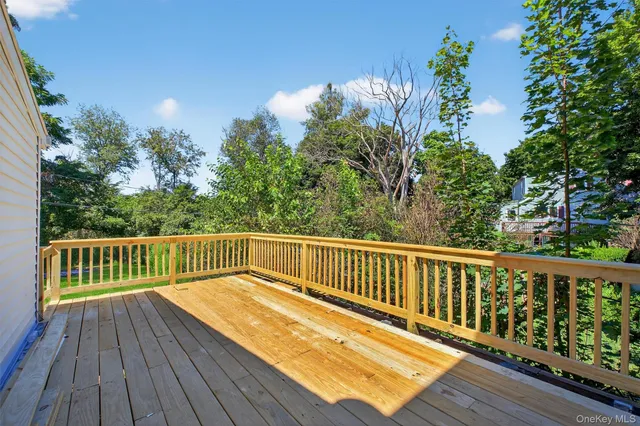 a view of balcony with wooden floor and fence