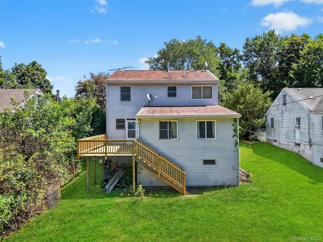 a aerial view of a house with a yard balcony and furniture