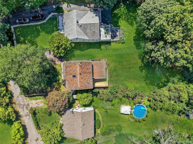 an aerial view of a house with a yard