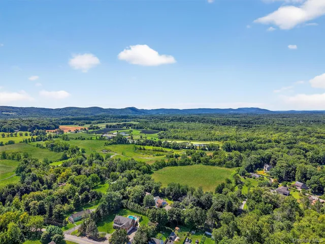 a view of a lush green outdoor space with a swimming pool and valleys