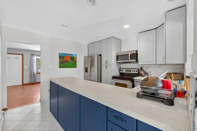 a kitchen with cabinets and appliances