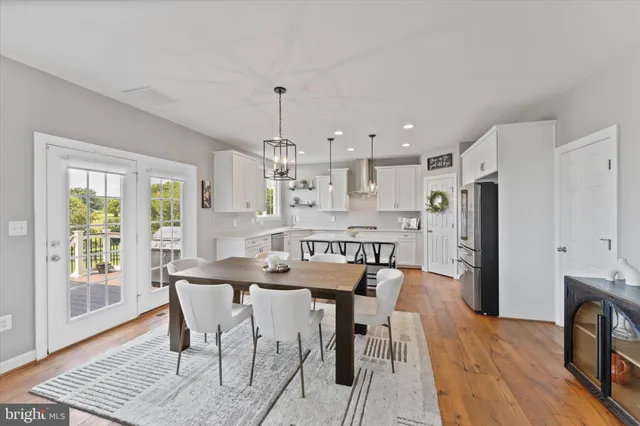a kitchen that has a lot of cabinets and stainless steel appliances