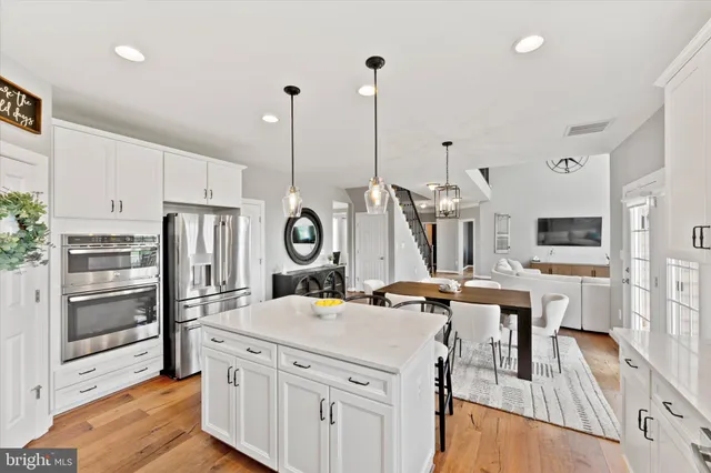 a spacious bedroom with a bed and a chandelier