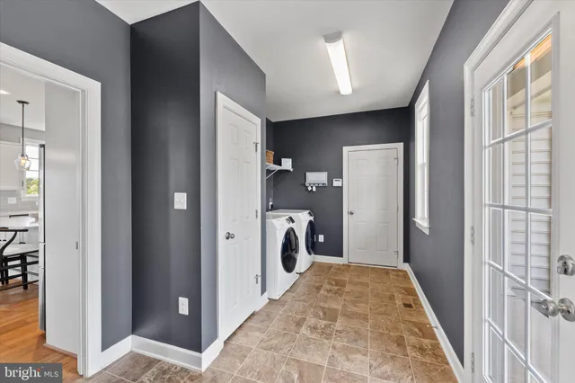 a bedroom with a large bed a chandelier and a window