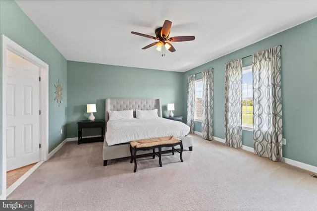 a bedroom with a bed and a lamp