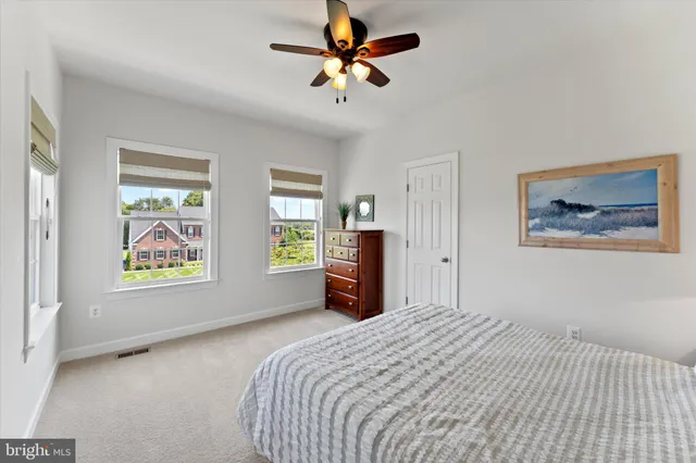 a kitchen with stainless steel appliances granite countertop a table chairs stove and refrigerator