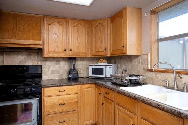 a kitchen with a stove and a refrigerator