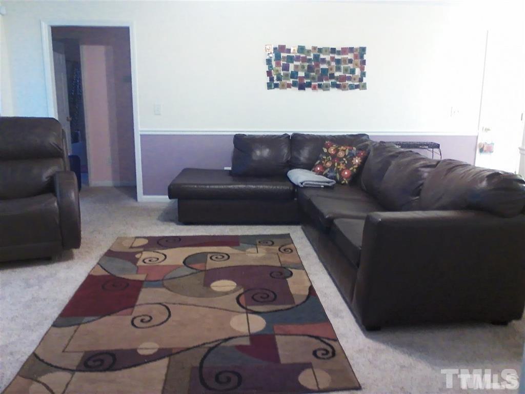 127 Rosa Circle Willow Spring, NC 27592 - Photo 3 of 10 a living room with furniture and a rug