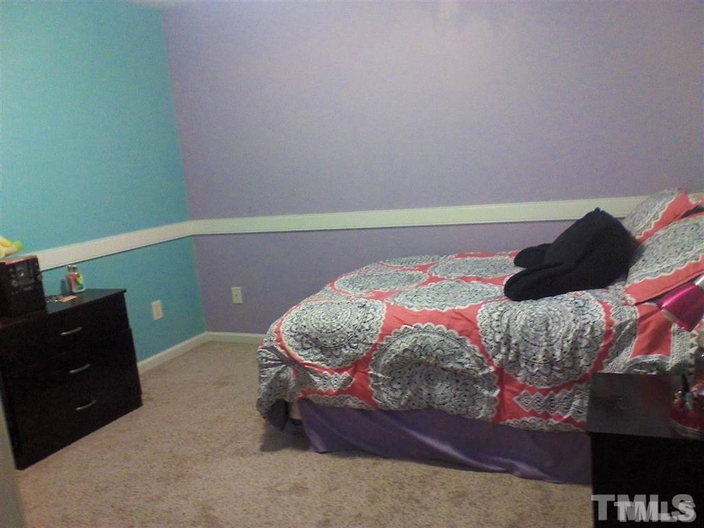 127 Rosa Circle Willow Spring, NC 27592 - Photo 8 of 10 a bedroom with a bed and a dresser