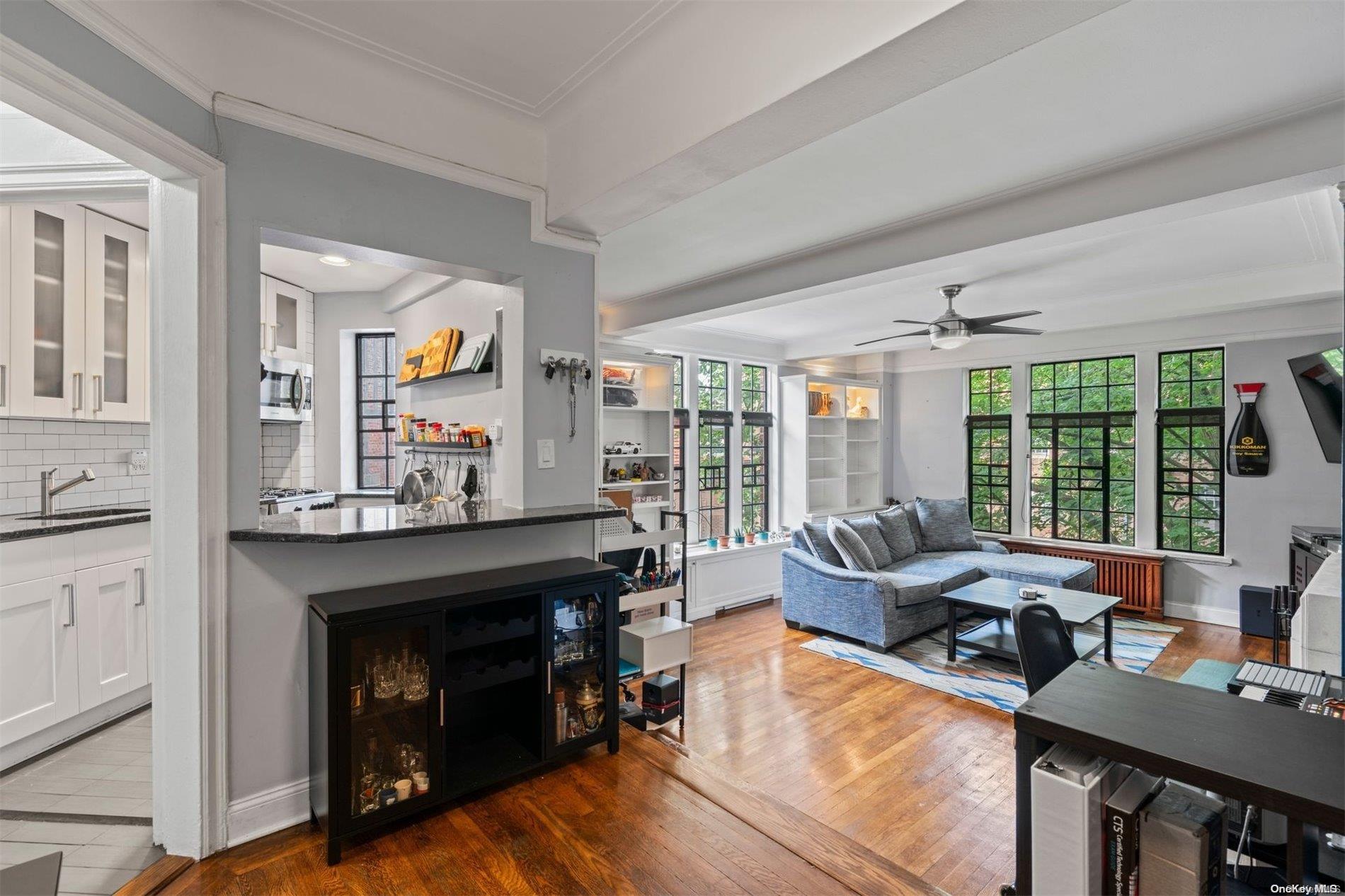 20 Continental Avenue, Unit 4C Queens, NY 11375 - Photo 1 of 1 a living room with furniture and a fireplace