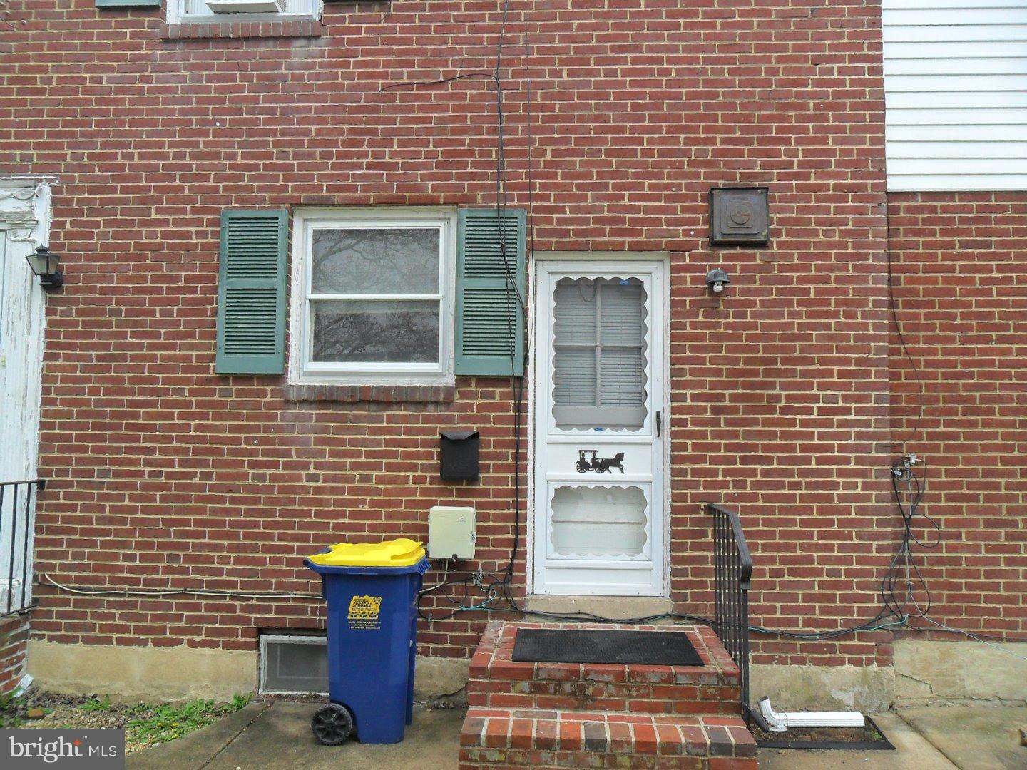 a view of a brick house with a fountain