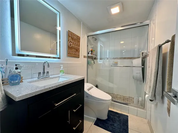 a bathroom with a sink toilet and shower