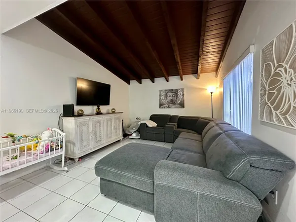 a living room with furniture and a flat screen tv