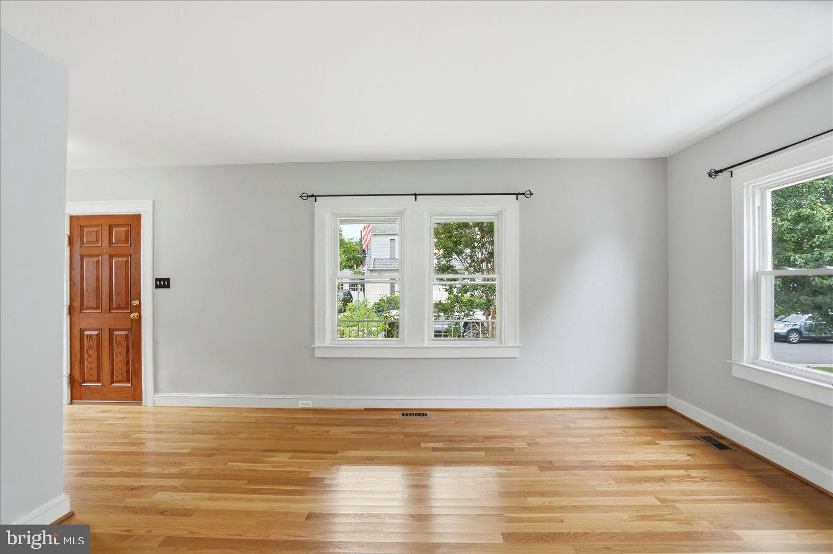 24 Normal Terrace Baltimore, MD 21286 - Photo 5 of 37 a view of an empty room with wooden floor and a window