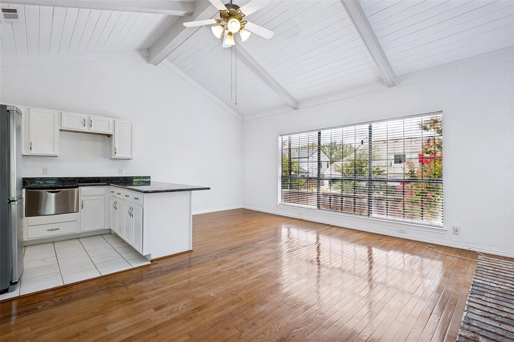 7055 Inwood Road Dallas, TX 75209 - Photo 10 of 24 a kitchen with stainless steel appliances a large counter top a sink a stove a chimney and a large window