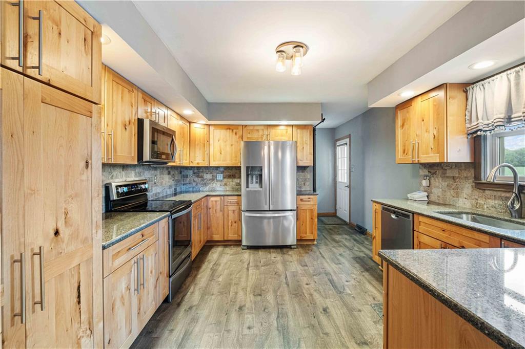 360 Golf Road Mercer, PA 16137 - Photo 9 of 25 a large kitchen with stainless steel appliances granite countertop a stove a sink dishwasher a microwave oven with granite countertops and cabinets