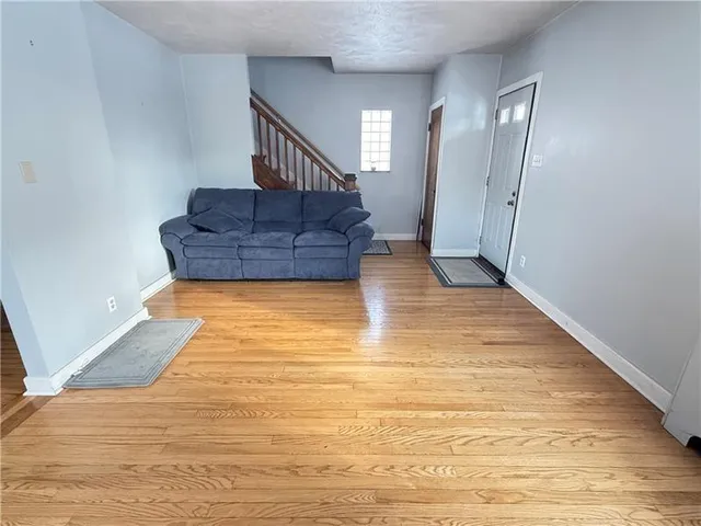 a living room with couch and a rug