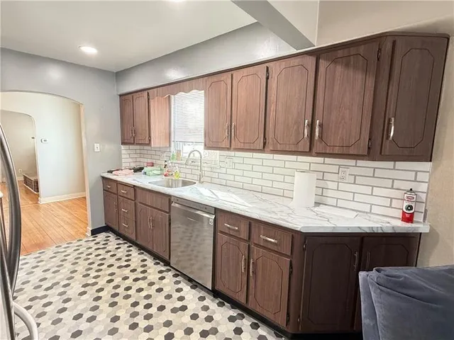 a kitchen with a sink stove and cabinets