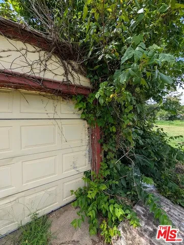 a view of a wooden house with a tree