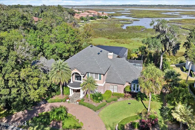 an aerial view of a house with a ocean view