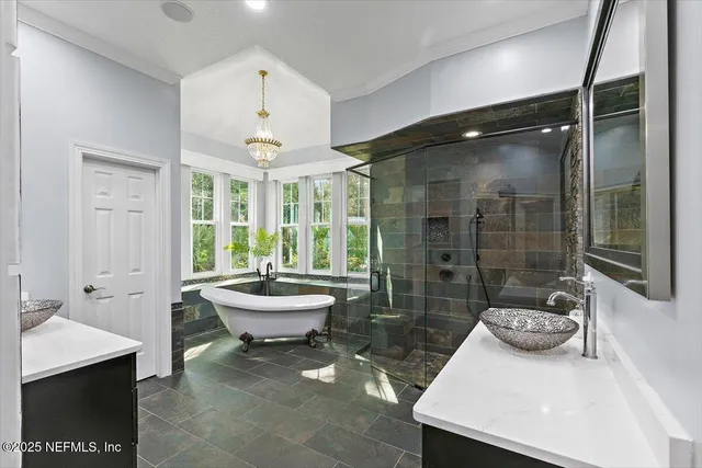 a living room with furniture and floor to ceiling windows